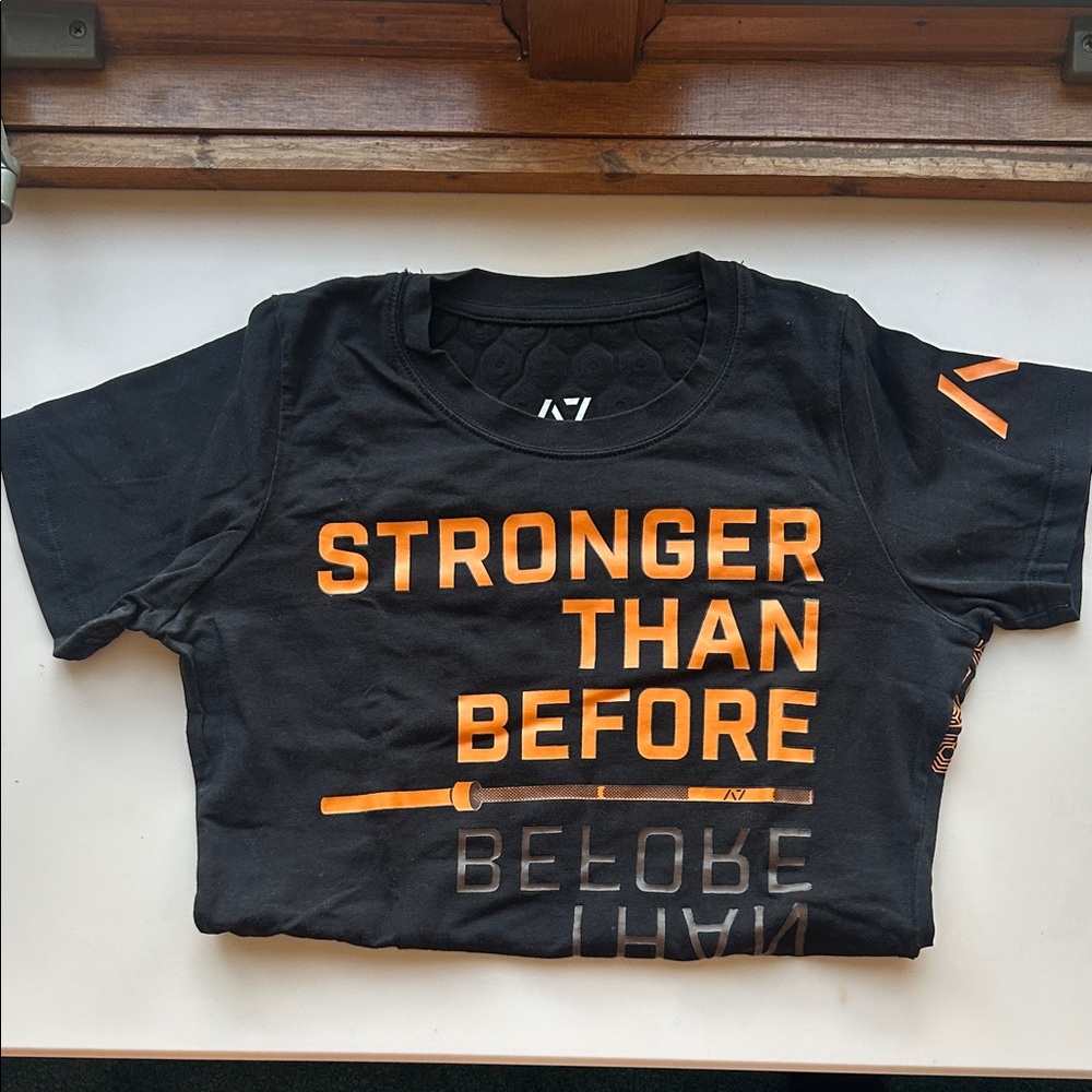 Black and Orange “Stronger Than Before” A7 Bar Grip Shirt